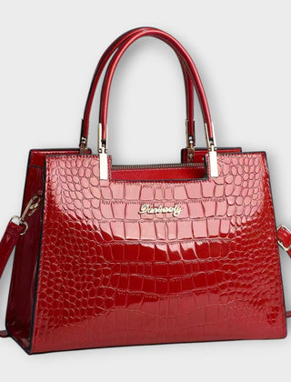 Shiny crocodile-pattern handbag in red with top handles and crossbody strap