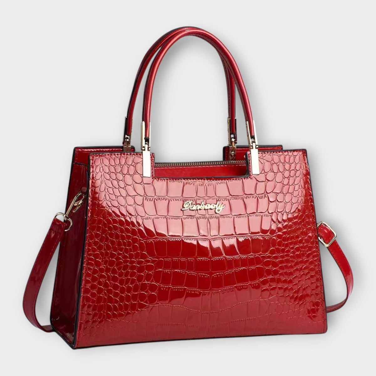 Shiny crocodile-pattern handbag in red with top handles and crossbody strap