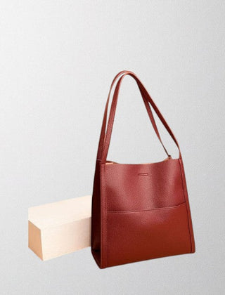 Red vegan leather shoulder bag with two top handles and structured front pocket
