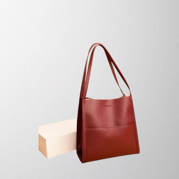 Red vegan leather shoulder bag with two top handles and structured front pocket