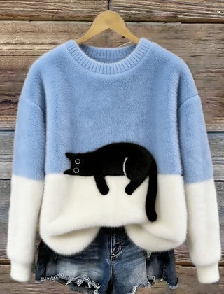 Light blue oversized sweater with white hem and cuffs, featuring a black penguin front graphic.