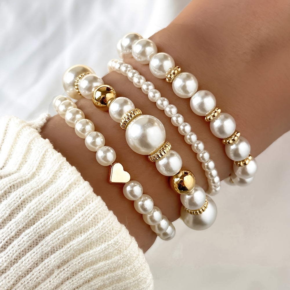Pearl heart bracelet set on wrist with white pearls and gold round heart details
