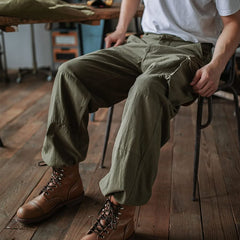 Army green cargo trousers with side pocket flaps and full-length relaxed legs