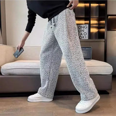 Light grey textured tapered pants with elastic waistband and drawstring ties
