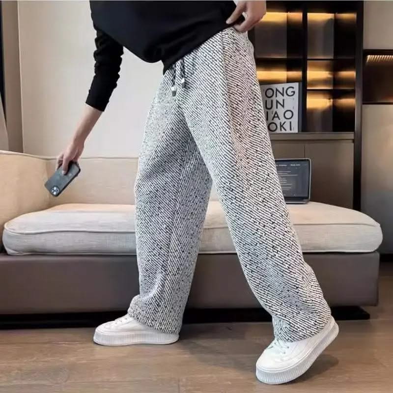 Light grey textured tapered pants with elastic waistband and drawstring ties