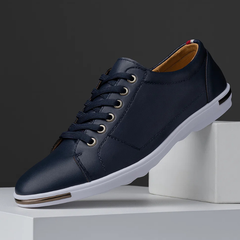 Navy leather low-top sneaker with lace-up front and white rubber sole
