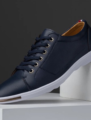 Navy leather low-top sneaker with lace-up front and white rubber sole