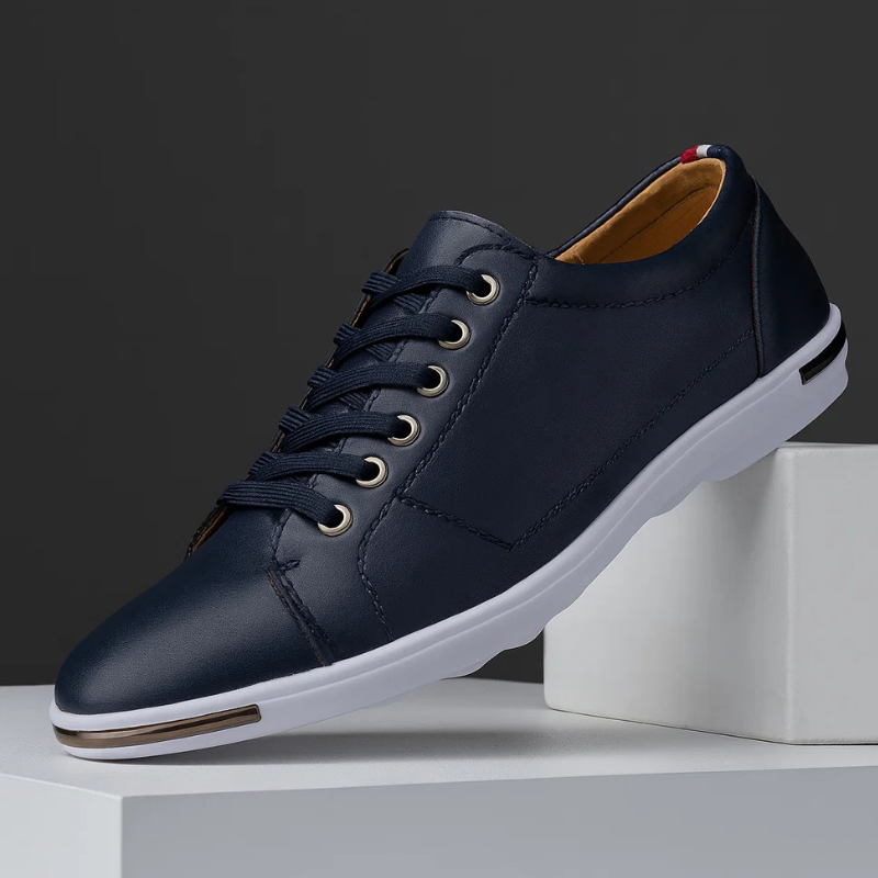 Navy leather low-top sneaker with lace-up front and white rubber sole