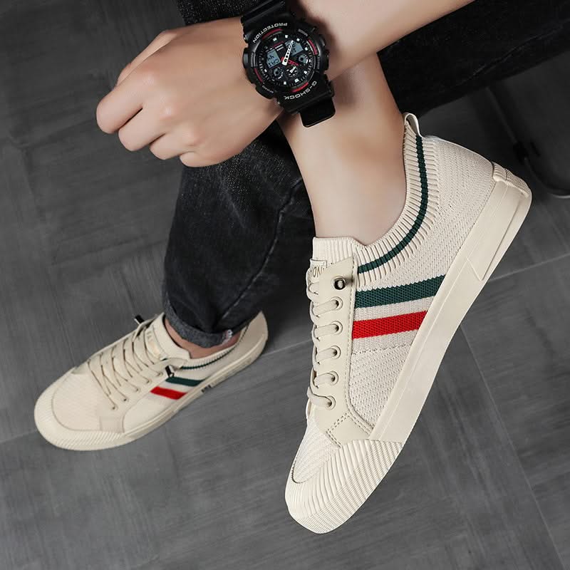 Sandstone knit sneakers worn with jeans; multicolor side stripe and lace-up front