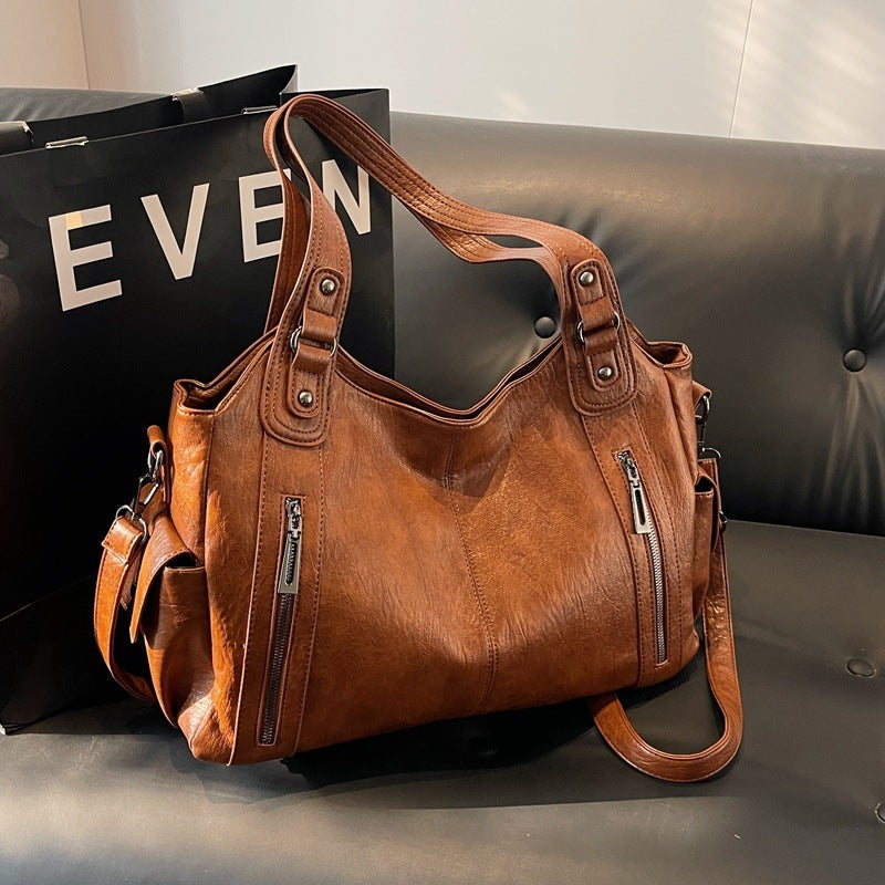 RAE Classic leather handbag, tan-brown leather with wide handles, front zip panels, and crossbody strap