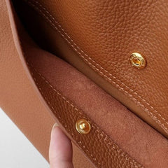 Brown vegan leather bag interior with stitched lining and snap fasteners