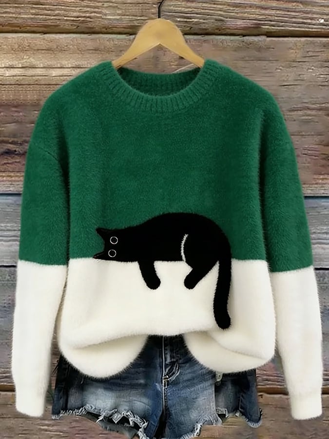 Green oversized fuzzy sweater with black-and-white penguin applique and white hem