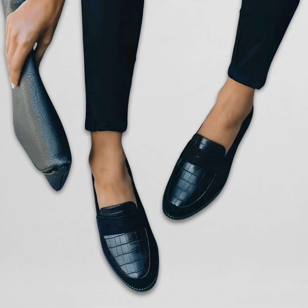 Dark blue croc-embossed leather loafer shown side view with top strap detail