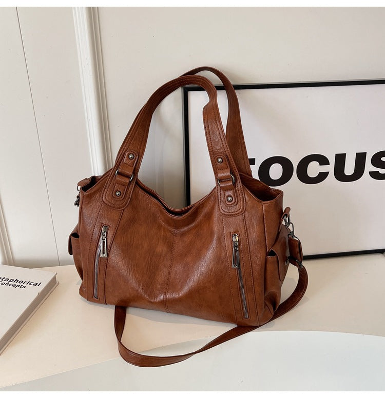 RAE Classic leather handbag, brown leather with top handles, front zippers, and long crossbody strap