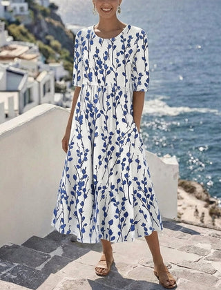Women’s white midi dress with blue botanical print, short sleeves, gathered waist