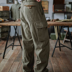 Army green cargo trousers with front button fly and flap cargo pockets