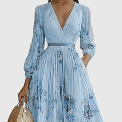 Light blue pleated maxi dress with V-neck wrap bodice and floral print, long sleeves.
