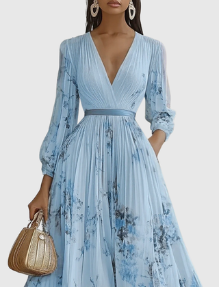 Light blue pleated maxi dress with V-neck wrap bodice and floral print, long sleeves.