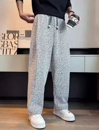 Light grey textured tapered pants with elastic waistband and drawstring ties