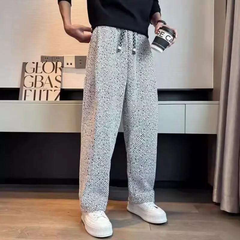 Light grey textured tapered pants with elastic waistband and drawstring ties