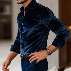 Navy velvet button-up shirt with long sleeves and pointed collar, side view.