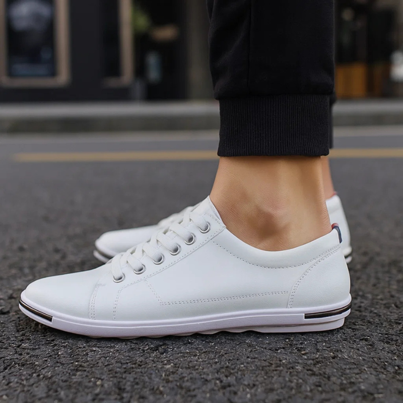 White leather low-top sneaker with lace-up front and white rubber sole