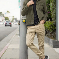 Beige slim trousers with tapered legs, button waist, and side pockets