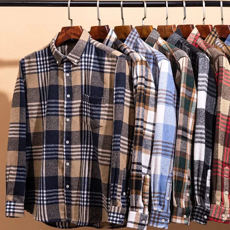 Assorted cotton flannel plaid button-up shirts on hangers, multiple colorways.