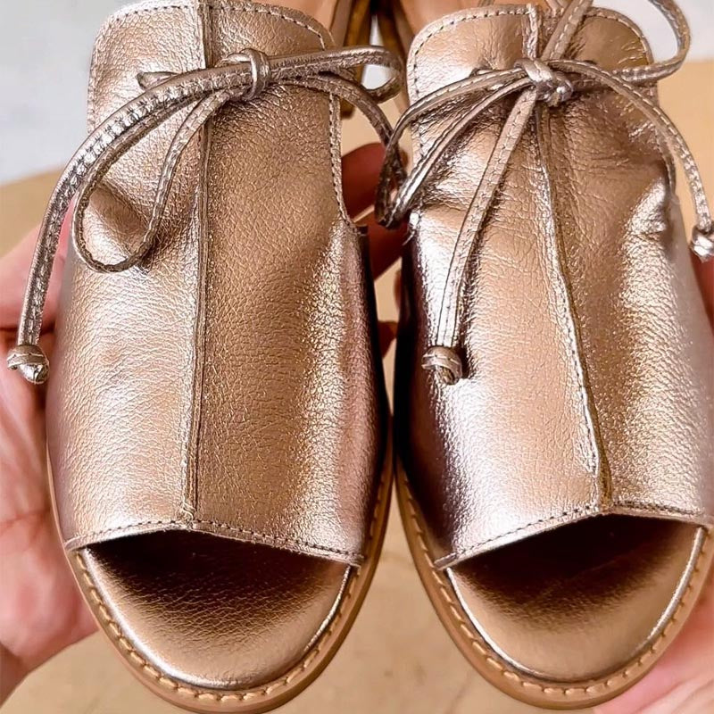 Champagne leather open-toe sandals close-up, lace tie ankle straps