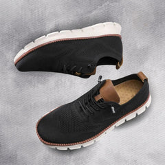 Black knit lace-up walking shoes with brown-trimmed sole and cushioned tread