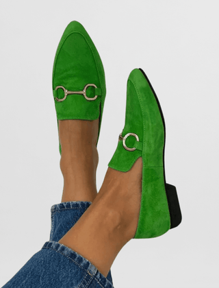 Green suede loafers with gold ring buckle hardware
