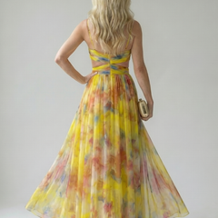 Back view of yellow multicolor sleeveless maxi wrap dress with tied waist and open back.