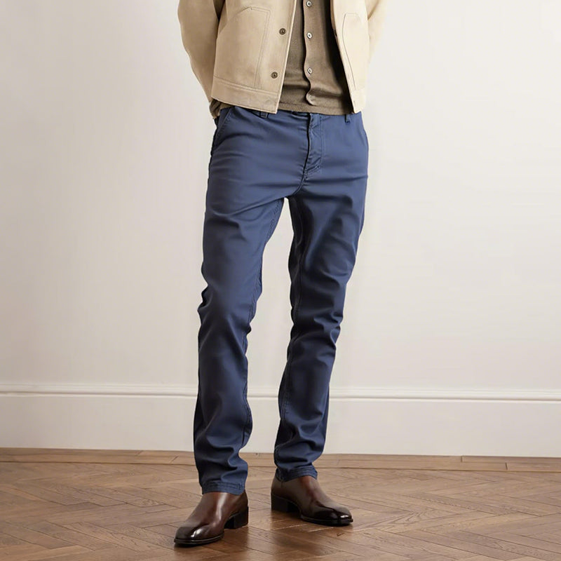 Navy blue slim trousers with button closure, belt loops, and tapered legs