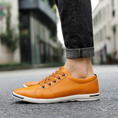 Orange leather low-top sneaker with lace-up front and white rubber sole