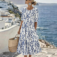 Women’s white midi dress with blue botanical print, short sleeves and swaying skirt