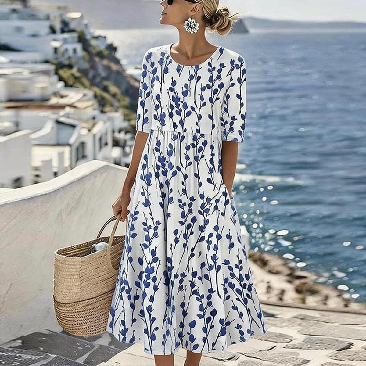 Women’s white midi dress with blue botanical print, short sleeves and swaying skirt