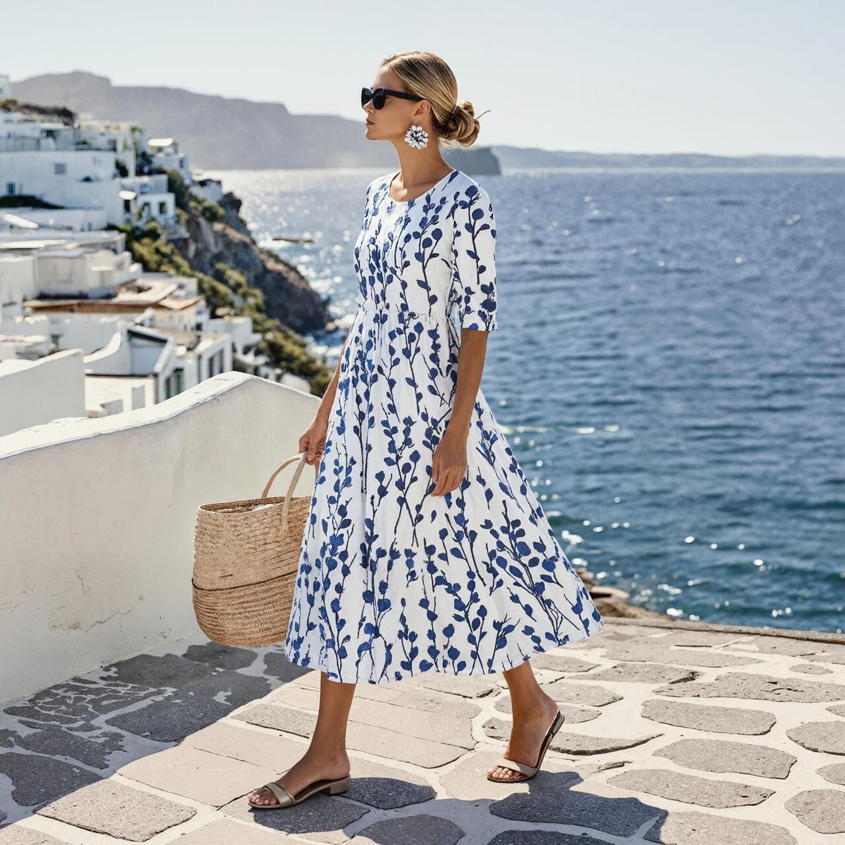 Women’s white midi dress with blue botanical print, walking full body, short sleeves