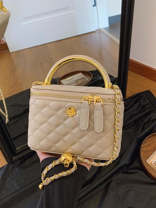 Cream quilted crossbody bag with gold-tone chain strap and top zip closure