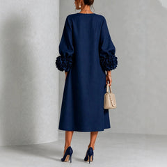 Navy floral midi dress back view with rose-cuff sleeves and buttoned back placket
