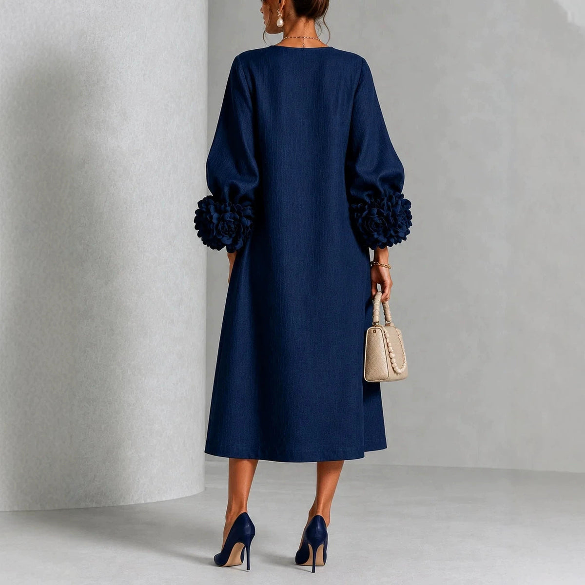Navy floral midi dress back view with rose-cuff sleeves and buttoned back placket