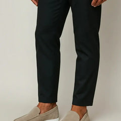 Khaki slip-on suede loafer worn with dark trousers