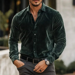 Green velvet button-up shirt with long sleeves and pointed collar.