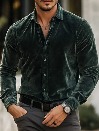 Green velvet button-up shirt with long sleeves and pointed collar.