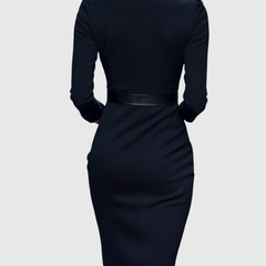 Back view of black fitted midi dress with long sleeves and waist belt with square buckle.