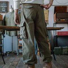 Army green cargo trousers with side flap pockets and cuffed ankle style