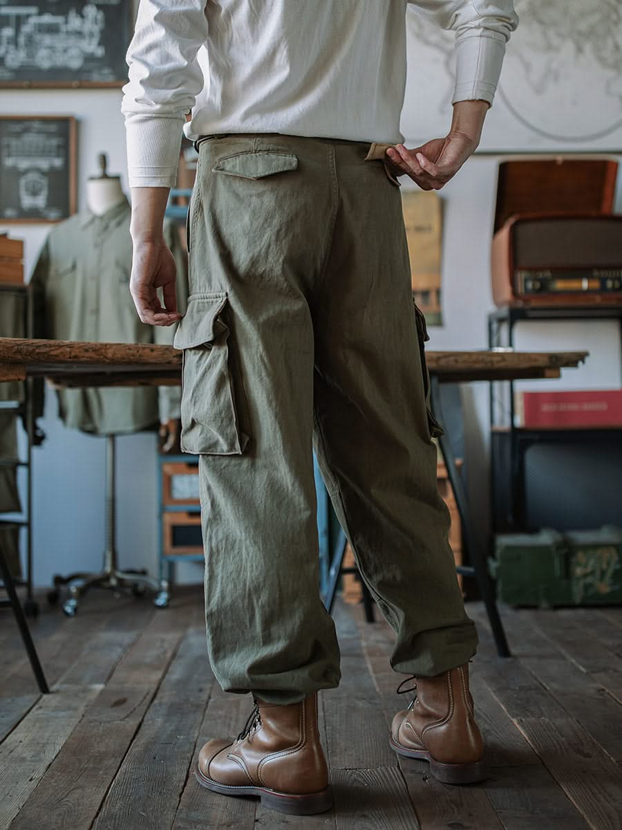 Army green cargo trousers with side flap pockets and cuffed ankle style