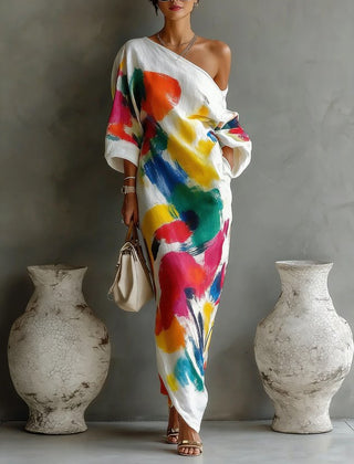 One-shoulder maxi dress in white with bold multicolor abstract paint pattern, draped sleeves