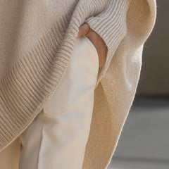 Pink drop-shoulder knit jumper with ribbed crew neck and draped asymmetric hem