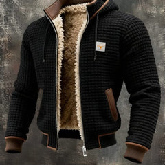 Black quilted fleece lined zip-front jacket with tan sherpa collar and brown pocket trim