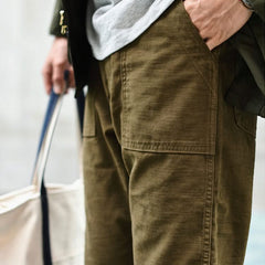 Olive straight fatigue pants with front flap pockets and stitched seams